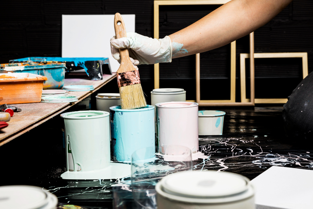 handsome-young-man-painting-wall-blue 1